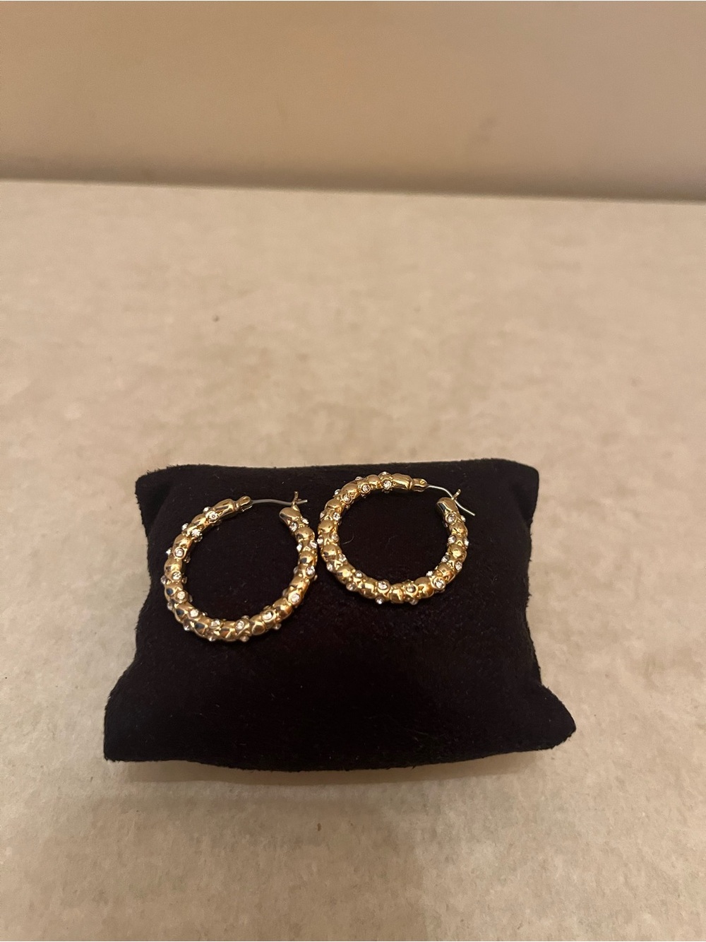 Gold tone with stones all around hoops.